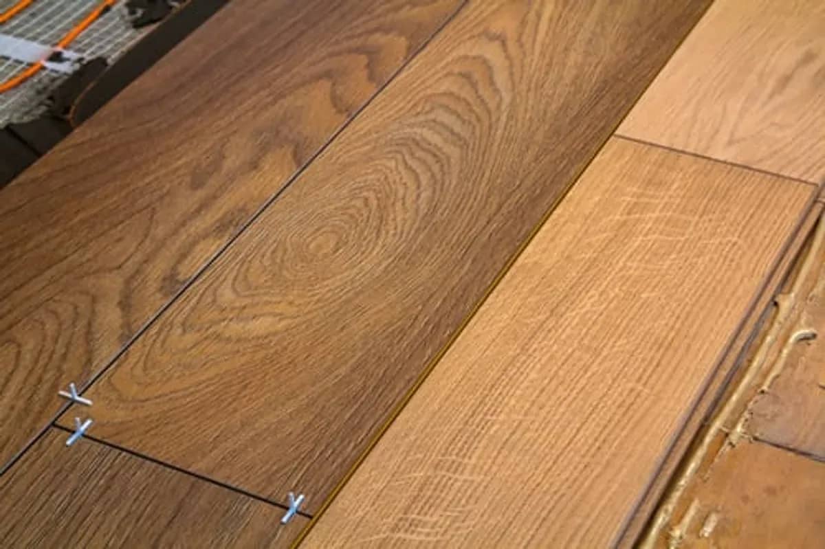 Hardwood flooring planks being installed over a prepared subfloor in a Connecticut home