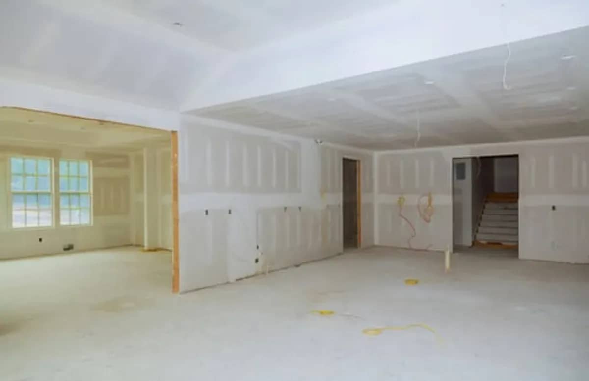 Newly hung and taped drywall in an open living space in Stamford, CT
