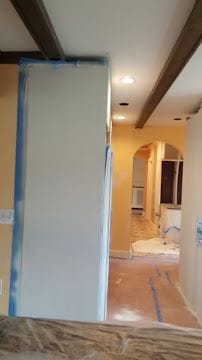 Interior painting and drywall preparation with masked trim during a Connecticut home renovation