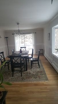 Finished dining room with hardwood flooring, fresh paint and new lighting in Stamford, CT