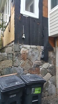 Natural stone foundation wall and exterior trim repair on the side of a Connecticut home