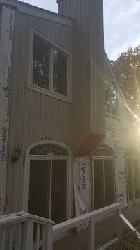 House wrap and new siding installation in progress on a two-story home in Fairfield County, CT