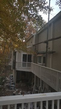Multi-level deck and porch construction with railings in progress on a Connecticut home