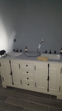 Custom double vanity with marble top and tile flooring in a remodeled bathroom in Fairfield County, CT